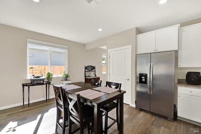 dining area featuring recessed lighting, visible vents, plenty of natural light, and wood finished floors