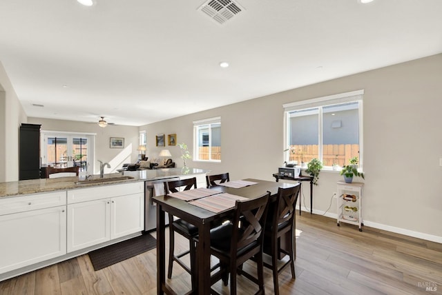 dining area featuring a ceiling fan, light wood-style flooring, baseboards, and visible vents