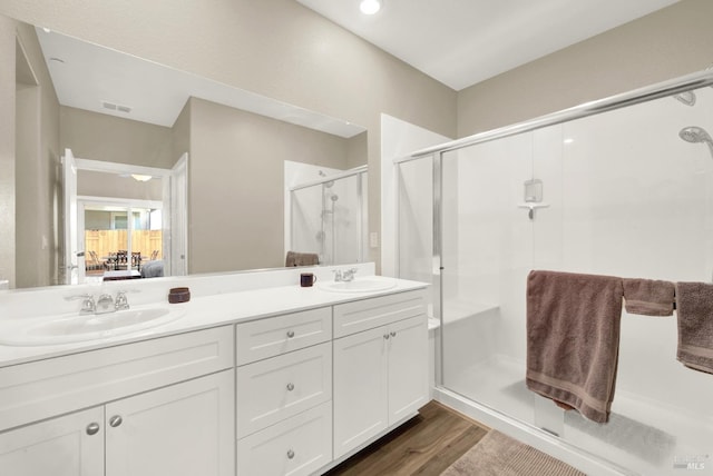 full bathroom featuring visible vents, a shower stall, connected bathroom, and a sink