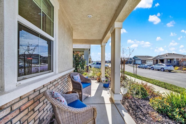 view of patio / terrace with a residential view and covered porch