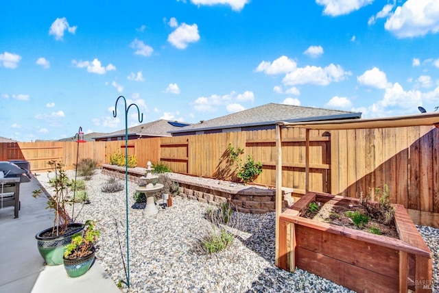 view of yard featuring a patio and a fenced backyard