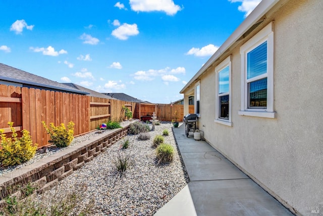 view of yard with a patio area and a fenced backyard