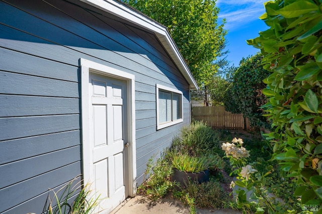 view of side of property featuring fence