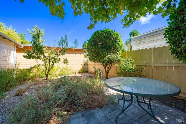 view of patio with outdoor dining space and fence