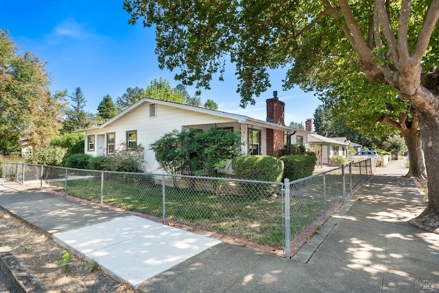 ranch-style house with a fenced front yard and a chimney