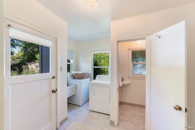 laundry area featuring washer and dryer, baseboards, and laundry area