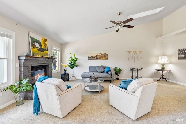 carpeted living room with baseboards, a brick fireplace, ceiling fan, and vaulted ceiling