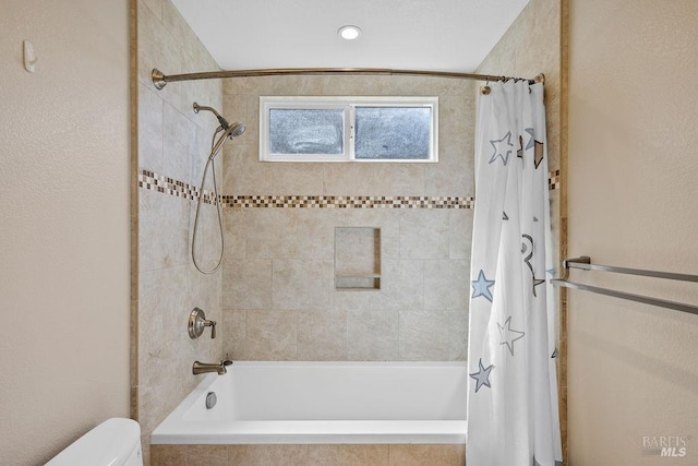 full bathroom with toilet and tiled shower / bath combo