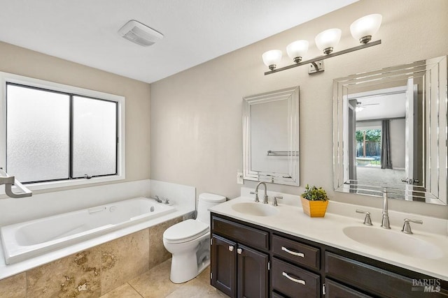 bathroom featuring double vanity, toilet, a bath, and a sink