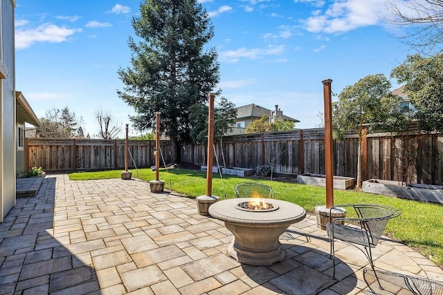 view of patio with a fire pit and a fenced backyard