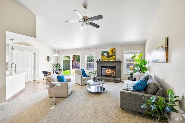 living area featuring light tile patterned flooring, a fireplace, light carpet, and a wealth of natural light