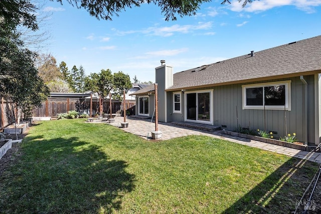 view of yard featuring a fenced backyard, a patio, and a garden