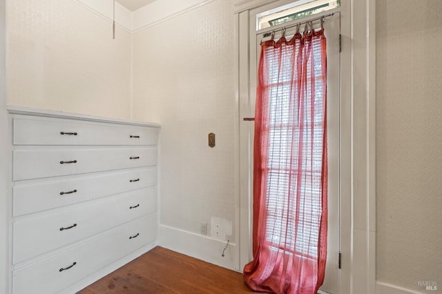 walk in closet with dark wood-type flooring