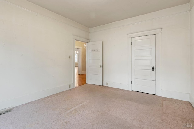 carpeted spare room with visible vents