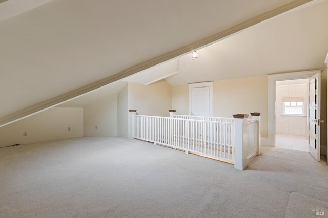 bonus room featuring light colored carpet and lofted ceiling