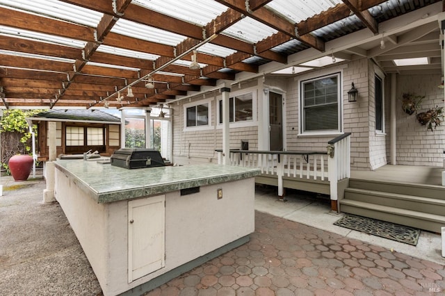 view of patio / terrace with grilling area, an outdoor kitchen, and a pergola