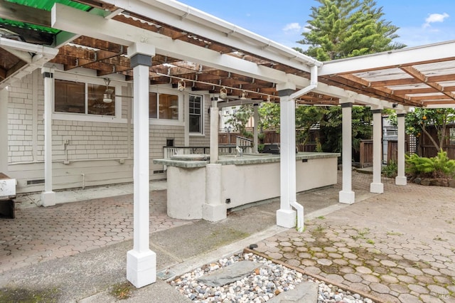 view of patio with fence and a pergola