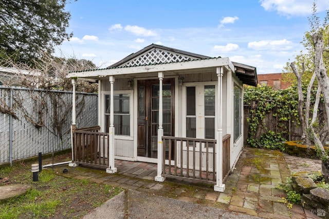 view of outdoor structure with a fenced backyard and french doors