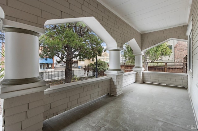 view of patio / terrace featuring fence and covered porch