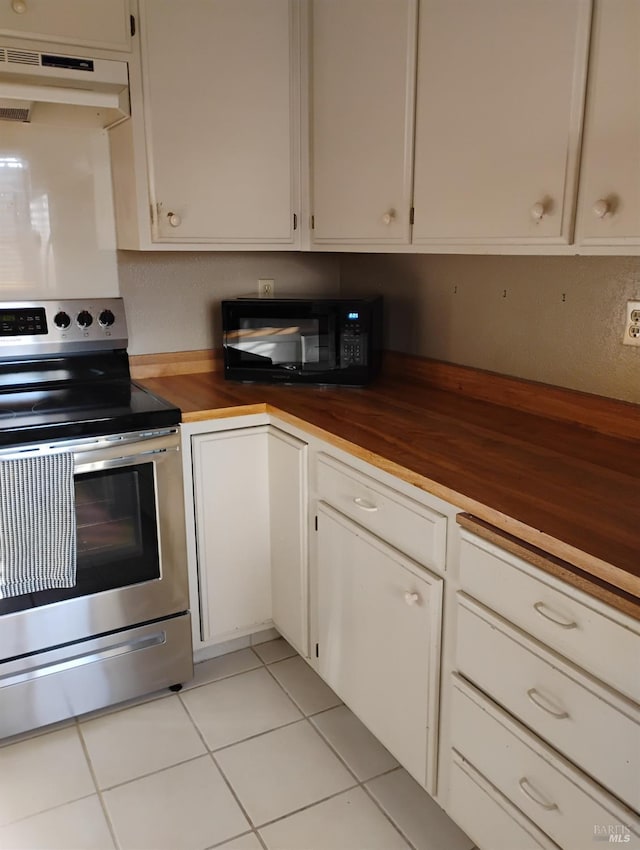 kitchen with under cabinet range hood, stainless steel electric stove, wood counters, and black microwave