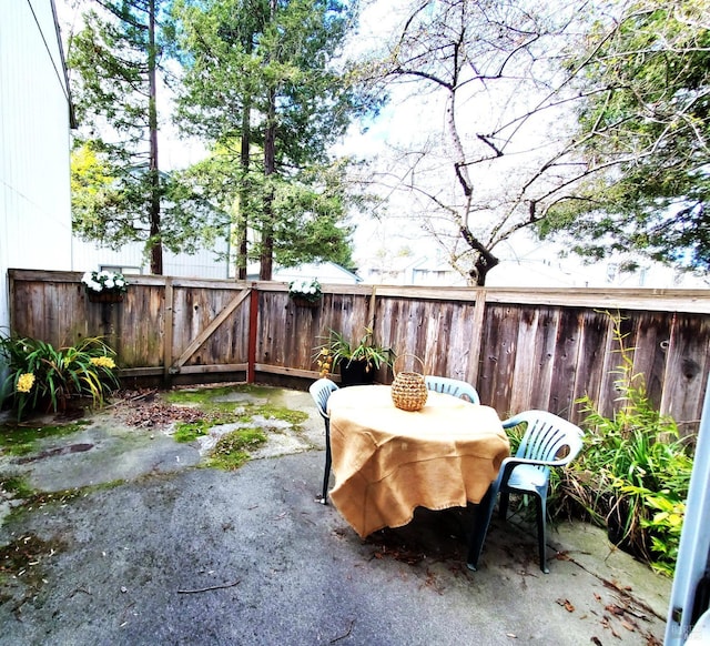 view of patio featuring outdoor dining space and fence