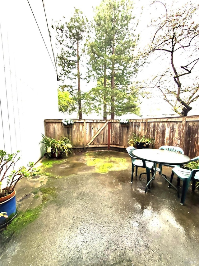 view of patio with a gate and fence