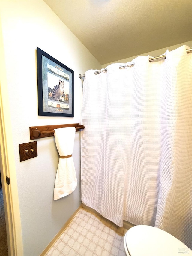 full bath featuring a shower with shower curtain, tile patterned floors, and toilet