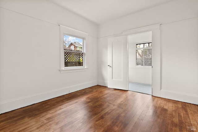 unfurnished bedroom featuring baseboards and hardwood / wood-style floors