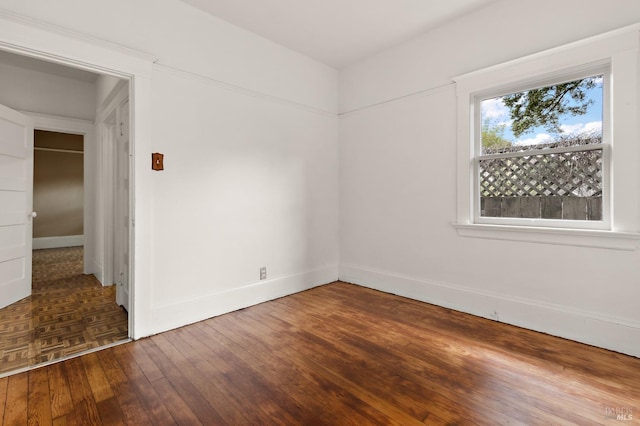 empty room with parquet floors and baseboards