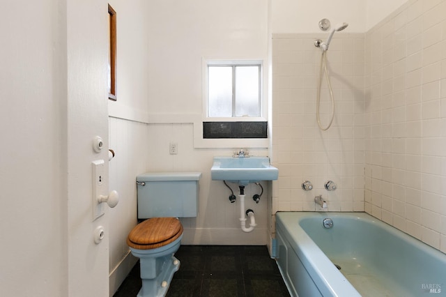 full bathroom with a sink, toilet, bathing tub / shower combination, and tile patterned floors