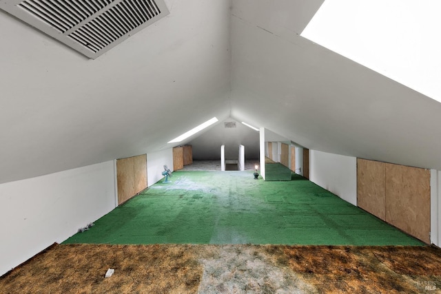 additional living space featuring lofted ceiling, carpet flooring, and visible vents