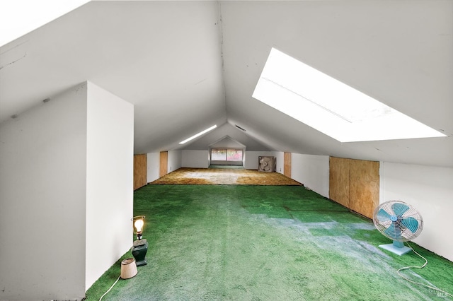 additional living space with lofted ceiling with skylight and carpet flooring