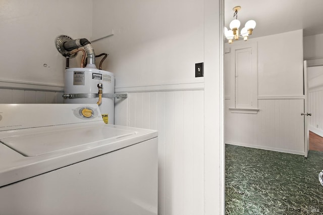 clothes washing area featuring a chandelier, a wainscoted wall, gas water heater, laundry area, and washer / clothes dryer