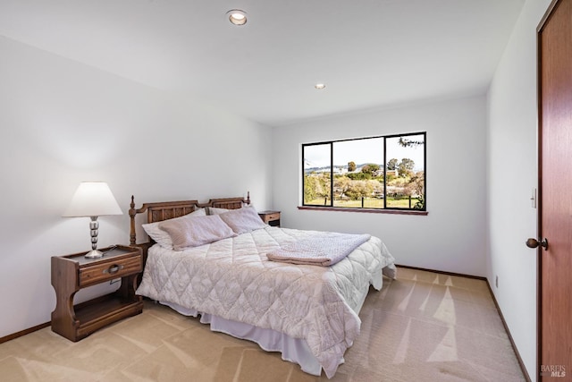 bedroom with light carpet, recessed lighting, and baseboards