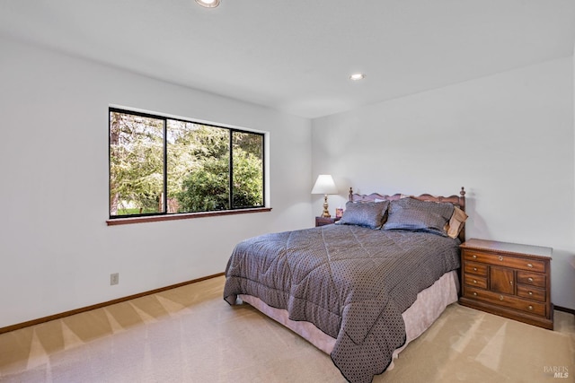 bedroom with recessed lighting, light colored carpet, and baseboards