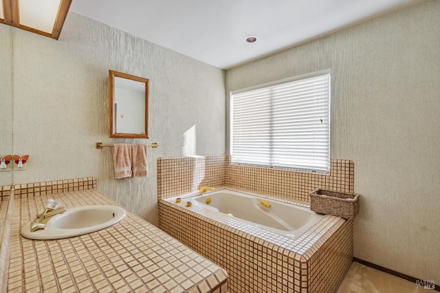 bathroom featuring a bath and a sink