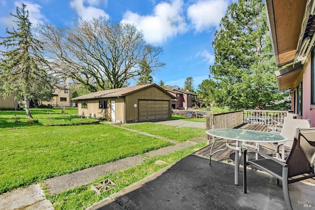 view of patio with an outbuilding, outdoor dining area, and a garage