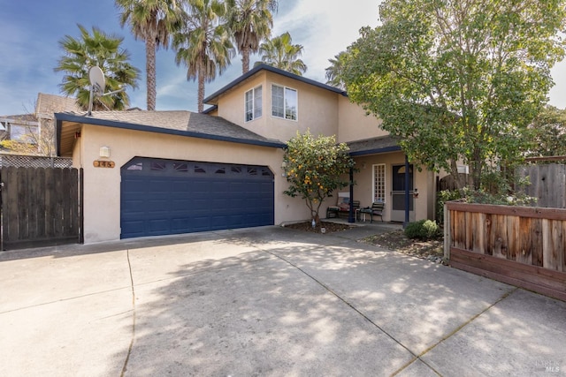 traditional-style home with stucco siding, covered porch, fence, a garage, and driveway