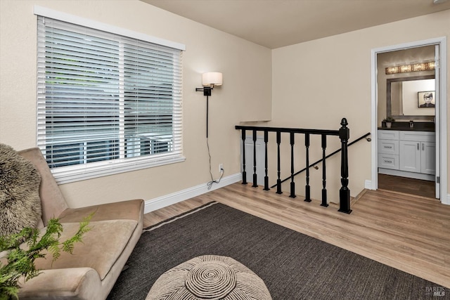 interior space with wood finished floors and baseboards