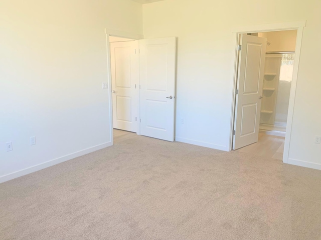 unfurnished bedroom with baseboards and carpet