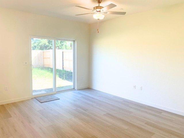 empty room with baseboards, light wood finished floors, and ceiling fan