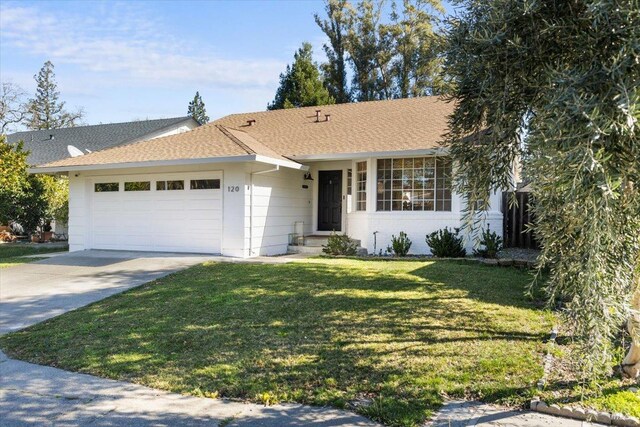 ranch-style home with a garage, a shingled roof, a front yard, and concrete driveway