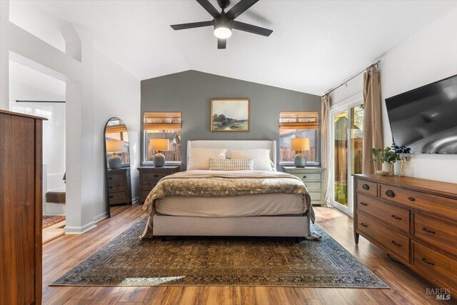 bedroom featuring ceiling fan, access to outside, vaulted ceiling, baseboards, and wood finished floors