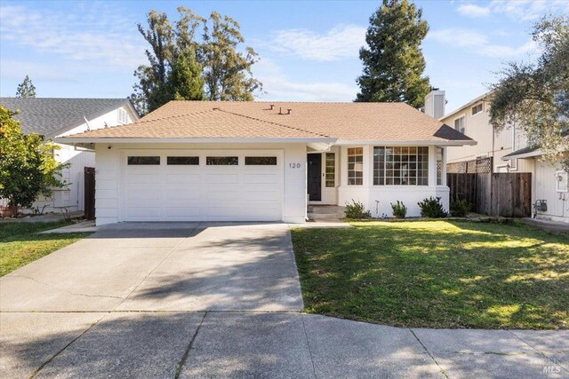 ranch-style house featuring fence, a front lawn, driveway, and an attached garage