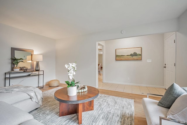 living area with light wood-style flooring and baseboards