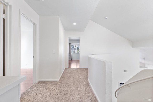 hall with recessed lighting, visible vents, light carpet, and baseboards