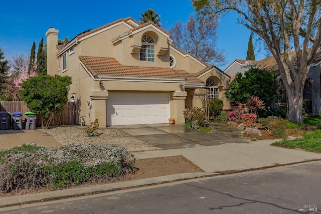 mediterranean / spanish home with fence, a tile roof, stucco siding, a chimney, and driveway