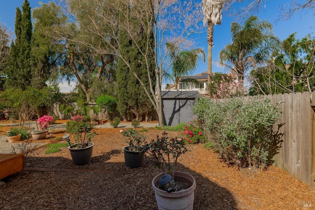 view of yard with an outdoor structure and a fenced backyard