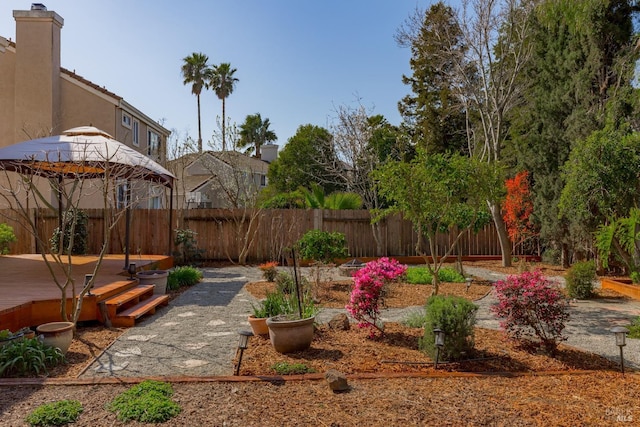 view of yard featuring a gazebo, fence, and a wooden deck