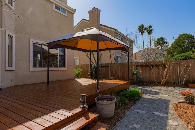 deck featuring a gazebo and fence